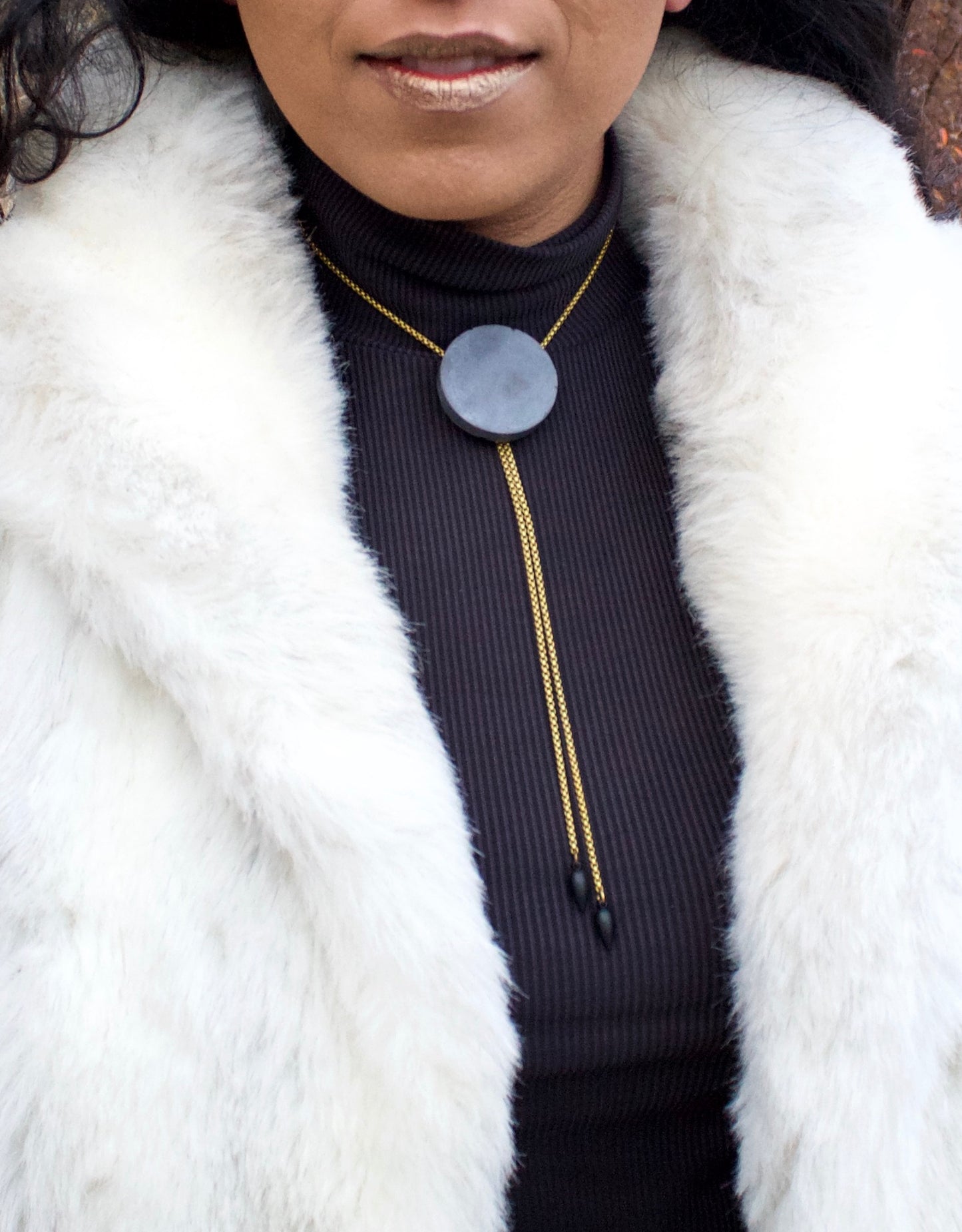 Concrete bolo tie necklace close up on a model