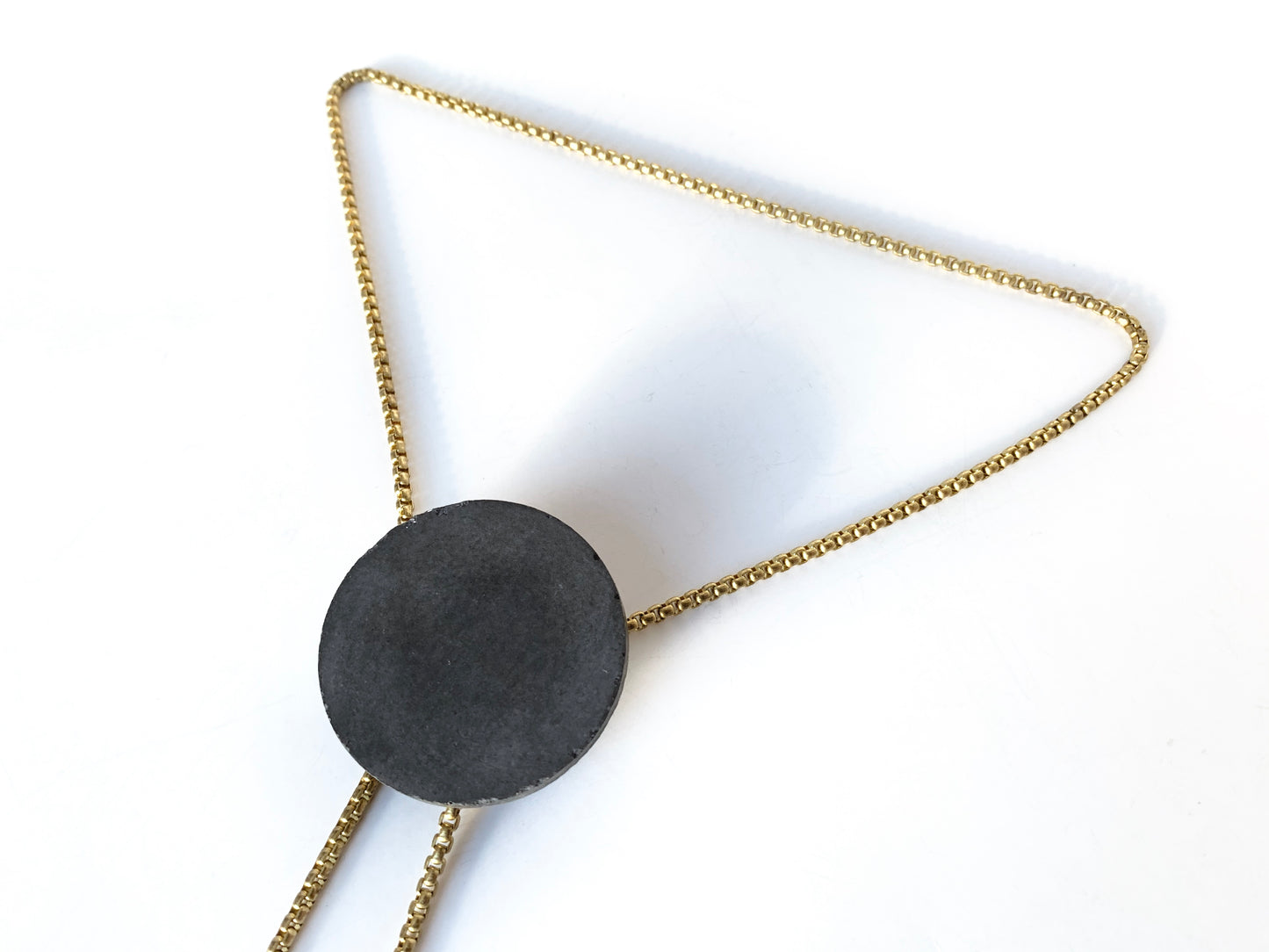 Side view of concrete pendant of bolo tie necklace
