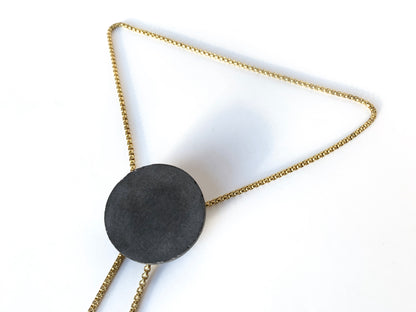 Side view of concrete pendant of bolo tie necklace