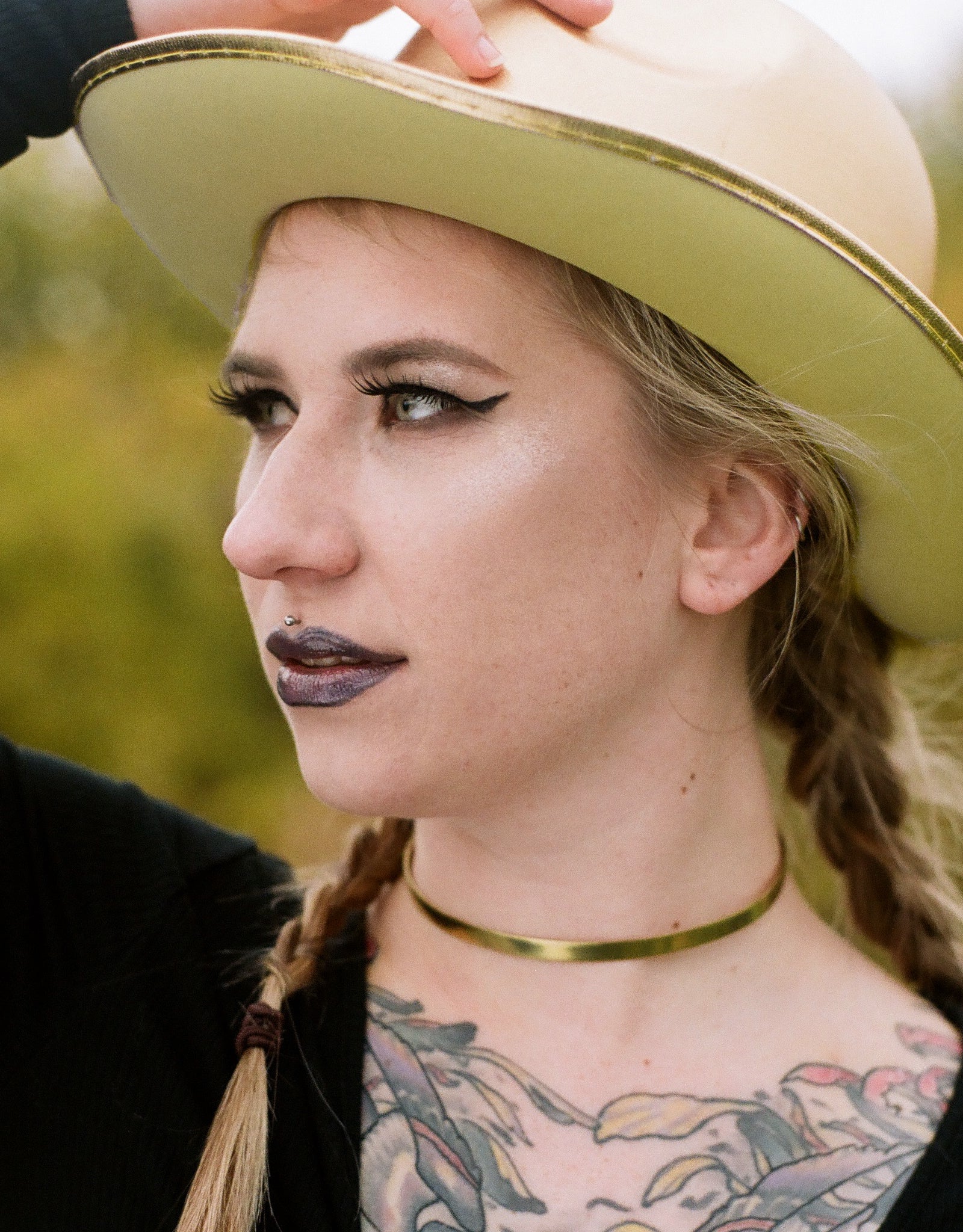 Model wearing gold neck choker