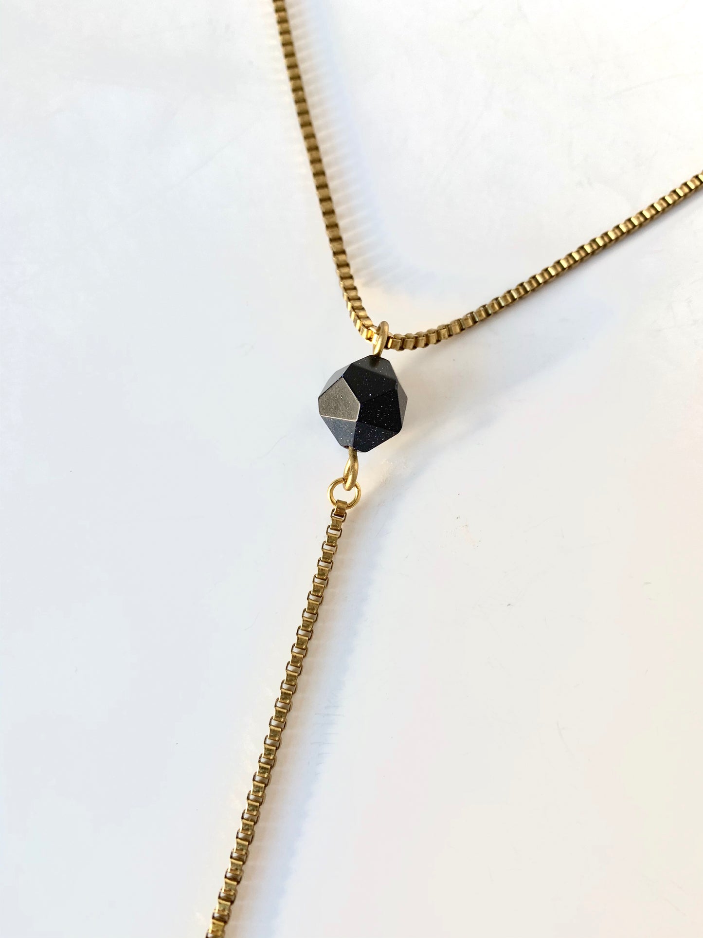 Blue goldstone pendant of gold lariat necklace