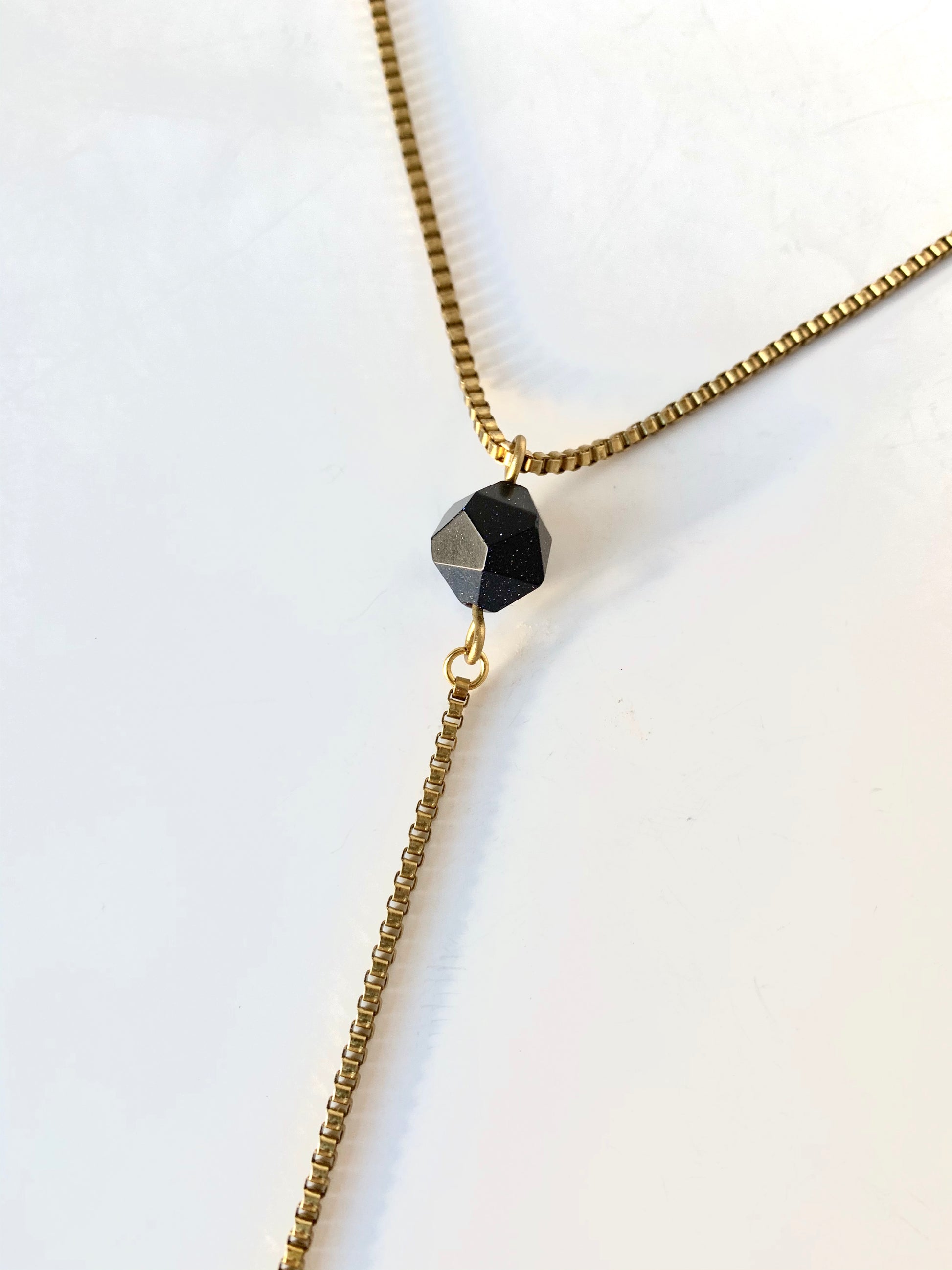 Blue goldstone pendant of gold lariat necklace