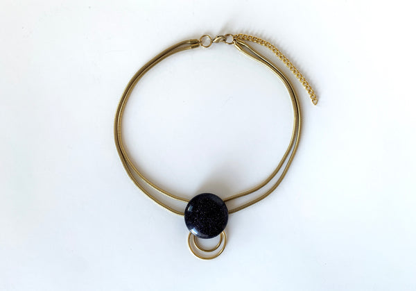Blue goldstone choker with hanging o rings and double gold snake chain