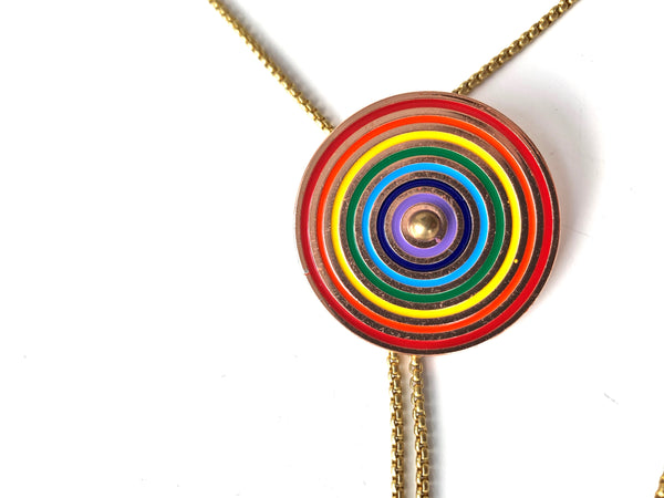 Rainbow pendant of bolo tie necklace on a white background
