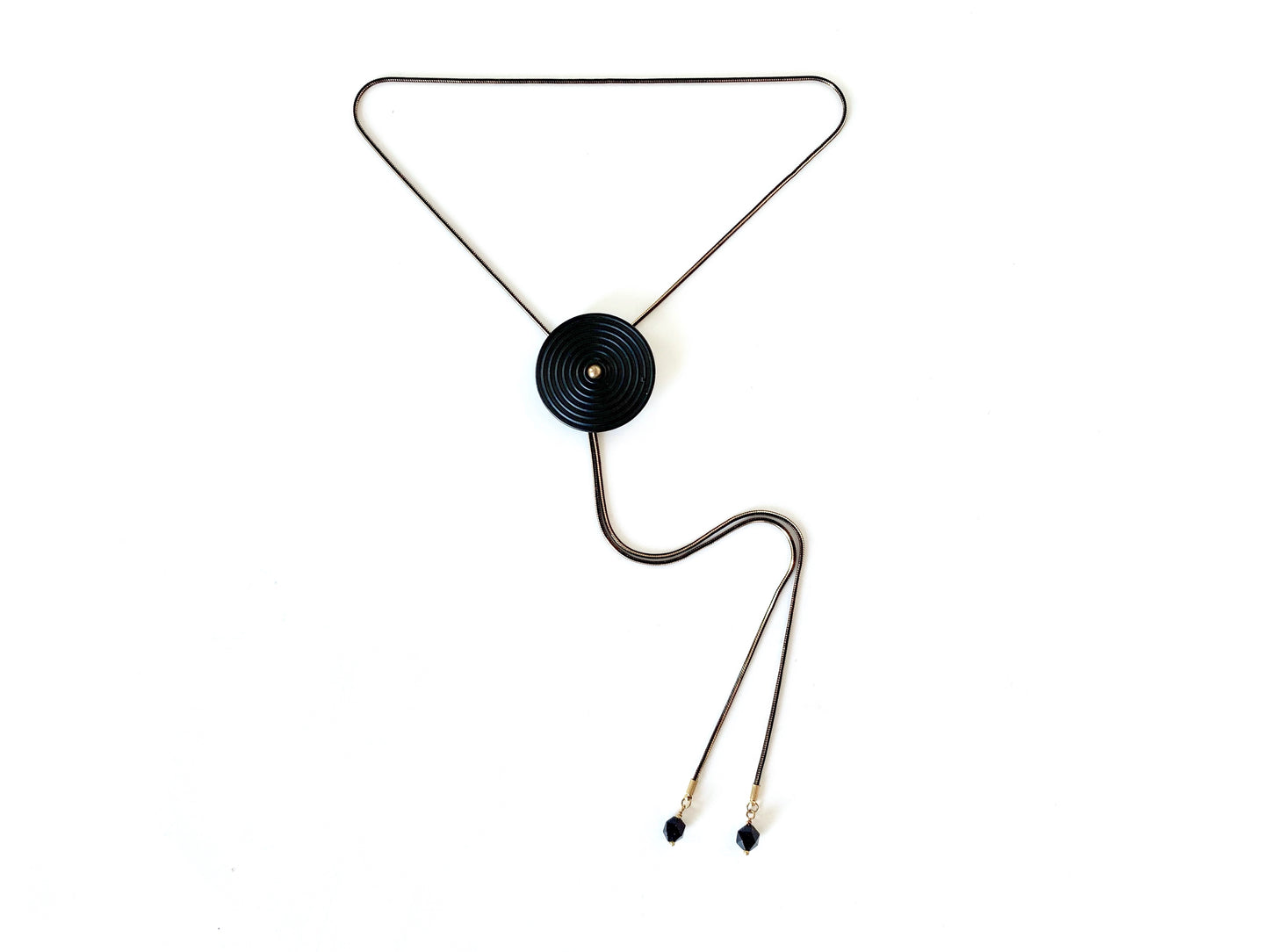 Black bolo tie necklace with circle medallion and goldstone bolo tips