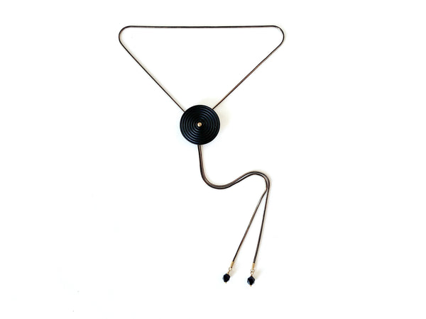 Black bolo tie necklace with circle medallion and goldstone bolo tips