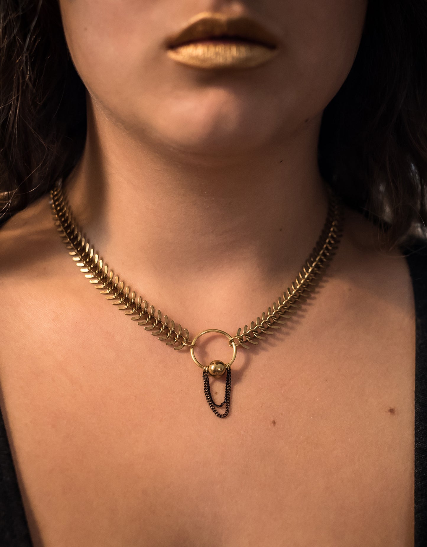 Model wearing gold fishbone choker