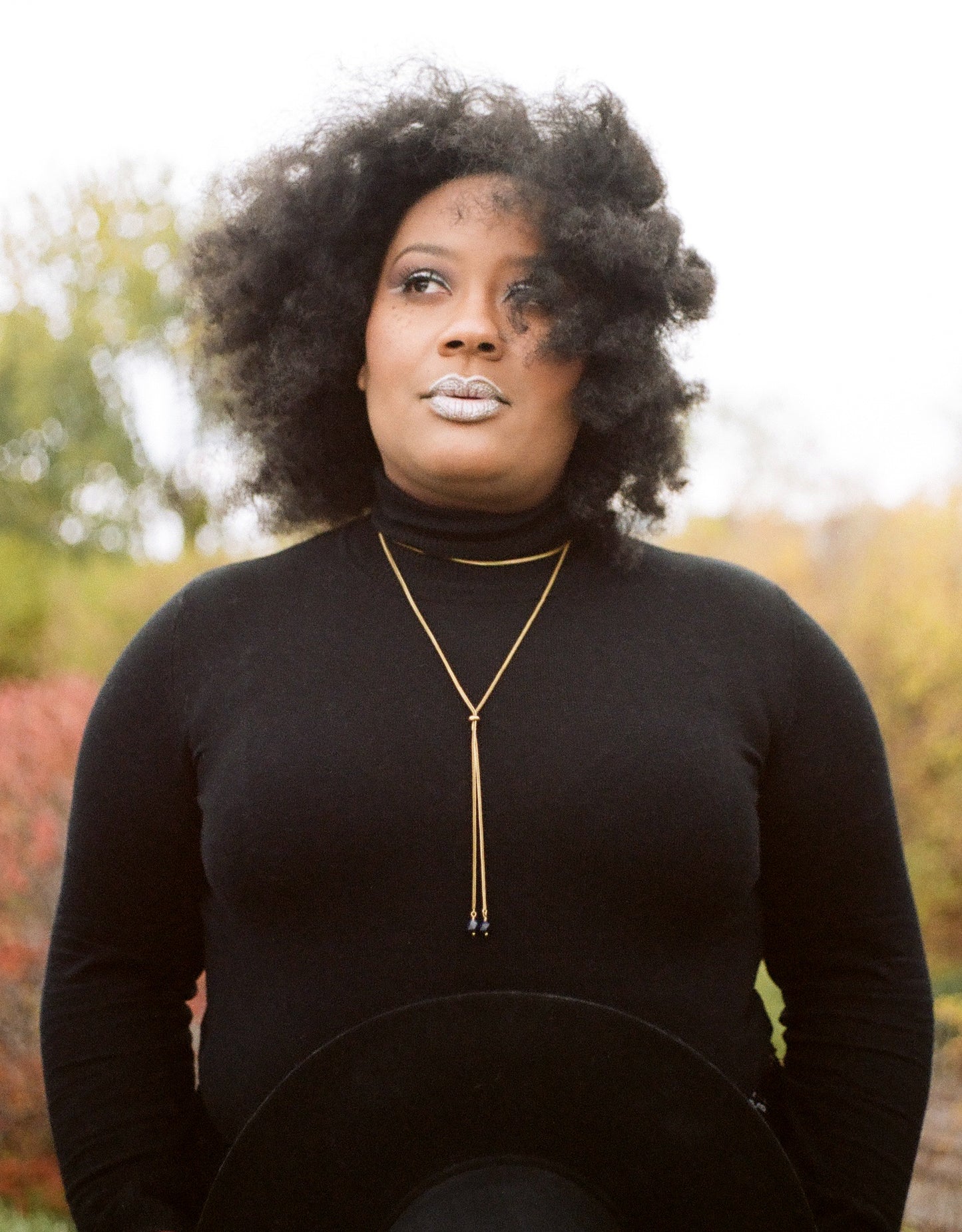 Front view of gold wrap necklace on a model