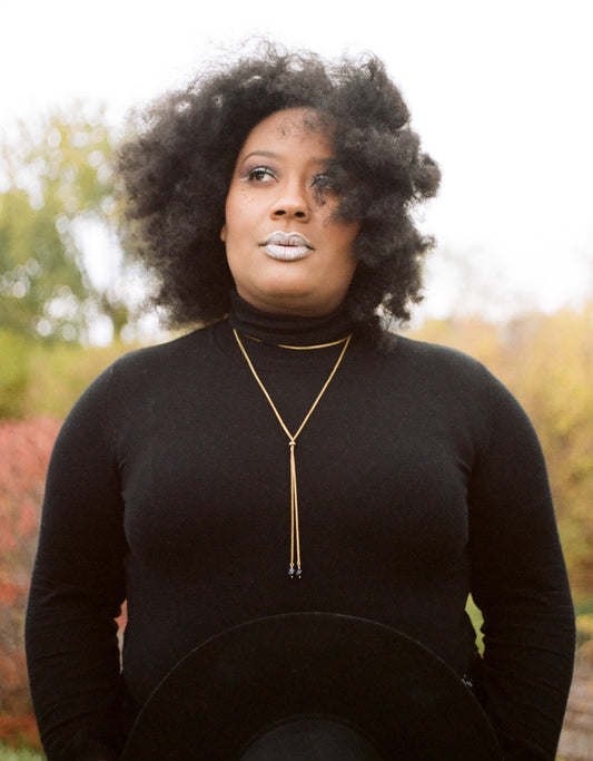 Front view of gold wrap necklace on a model