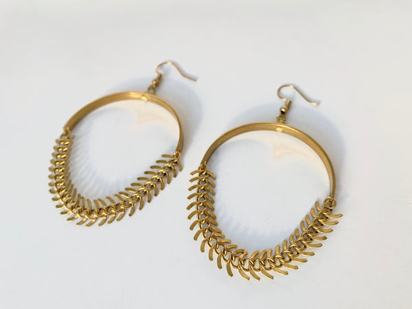 Side view of brass fishbone chain earrings