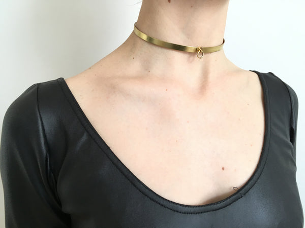 Model wearing gold choker collar