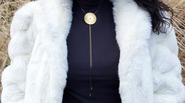 Close-up of large bolo tie necklace on a model