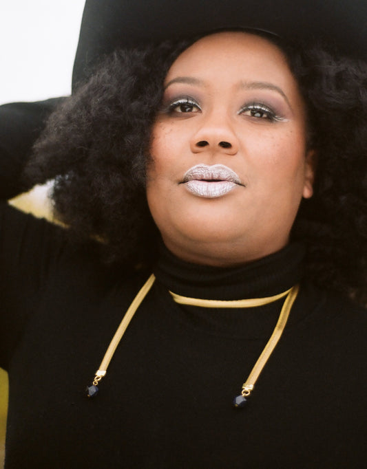 Model wearing gold wrap necklace