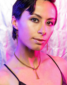Close up of model wearing rolo chain choker and matching earrings