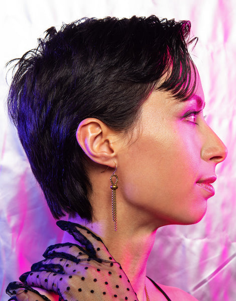 Side view of model wearing rolo chain earrings