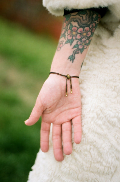 Back view of barbell bracelet on models wrist