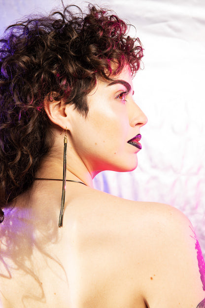 Back of model wearing long tassel earrings 