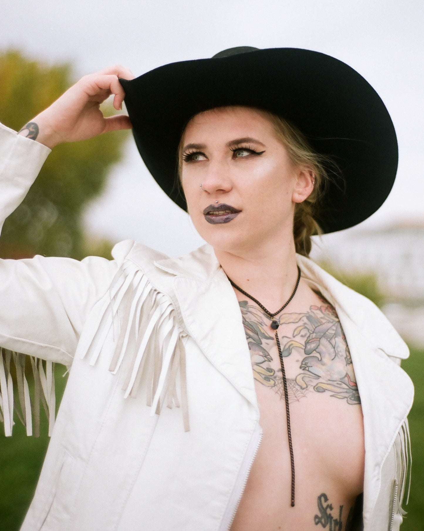 Model wearing black lariat necklace
