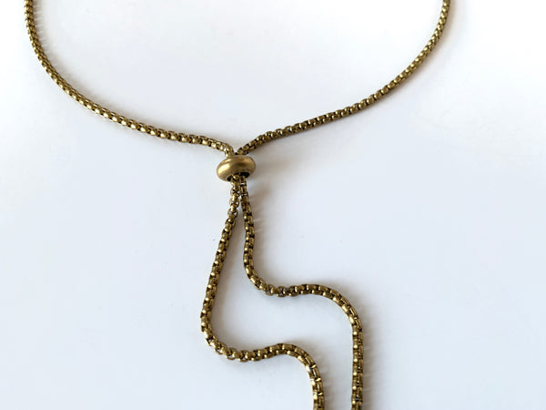 Close up of slide bead of gold bolo tie chain necklace