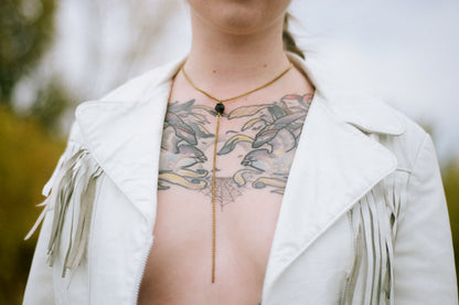 Gold drop necklace on model
