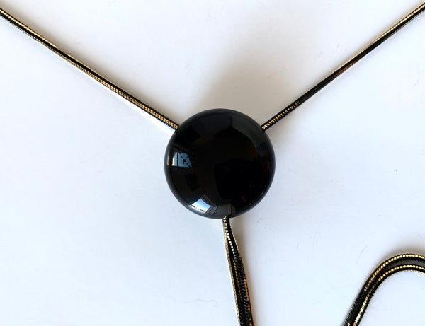 Close up of black onyx bolo tie pendant