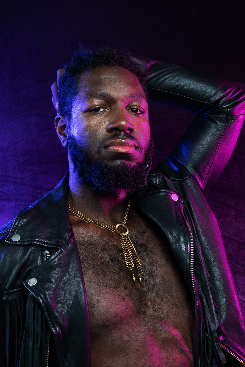 Side view of model wearing o ring choker and leather jacket