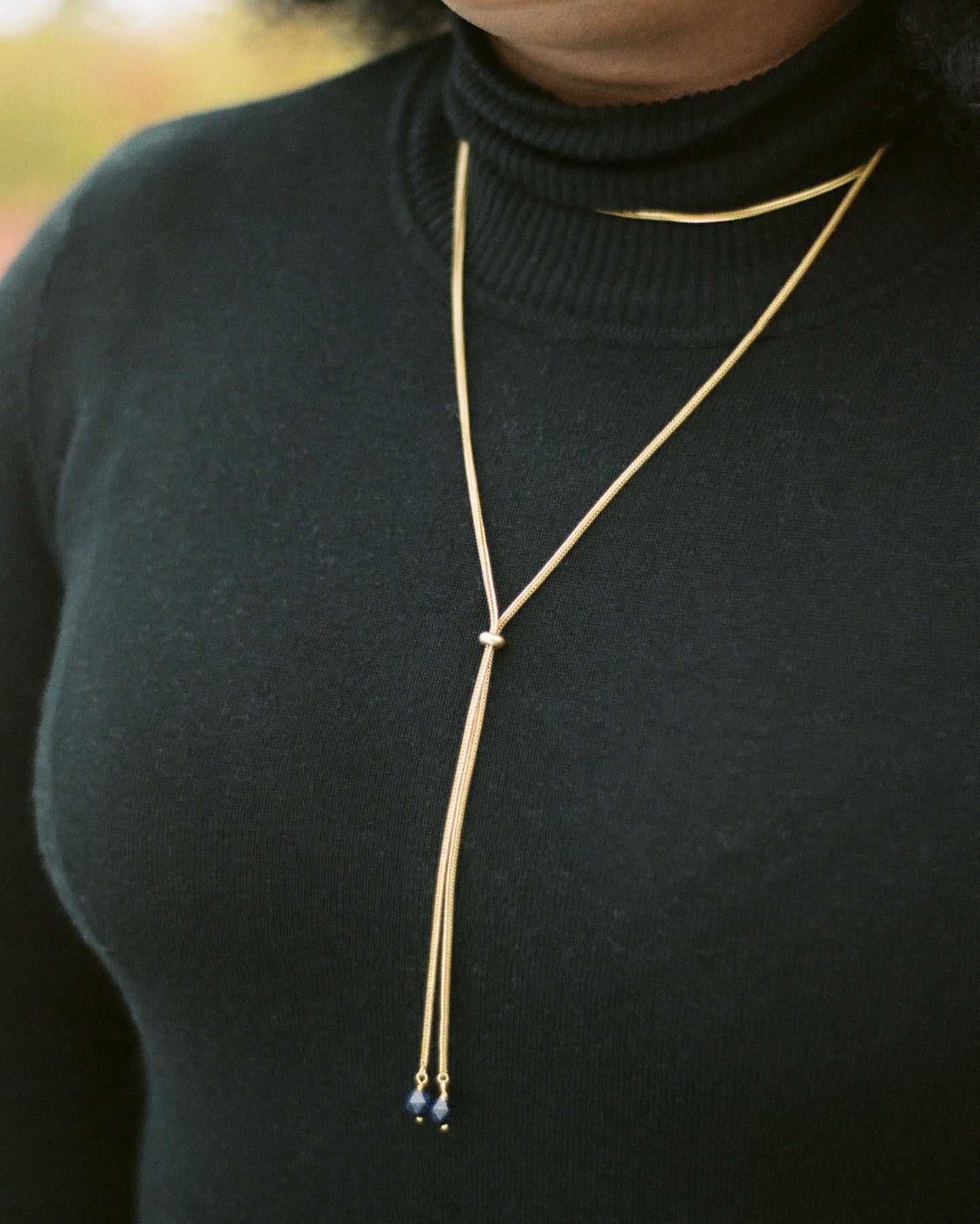 Close-up of foxtail chain necklace on a model